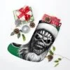 Christmas stocking featuring the iconic Iron Maiden skeleton with a Christmas hat, crafted from plush polyester fleece, ideal for metal fans seeking a unique holiday decoration