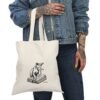 Personalized tote bag with a line drawing of a playful cat on a book, customizable with your cat's breed and name, made from eco-friendly cotton canvas.