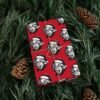 Red gift wrap paper featuring Albert Einstein with his tongue out and wearing a Christmas hat, available in matte and satin finishes, perfect for wrapping gifts with a fun, intellectual twist