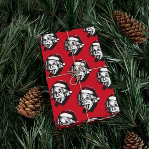 Red gift wrap paper featuring Albert Einstein with his tongue out and wearing a Christmas hat, available in matte and satin finishes, perfect for wrapping gifts with a fun, intellectual twist