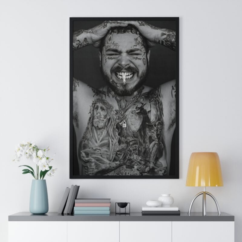 Close-up framed poster of Post Malone in a smoking pose, showcasing his unique tattoos and grills, in black and white, embodying the essence of his rebellious spirit.