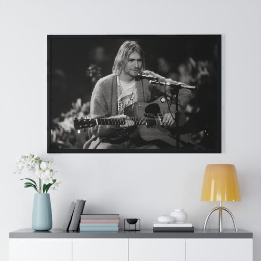 Iconic black and white poster of Kurt Cobain performing at MTV Unplugged in New York, showcasing his deep connection to the music.