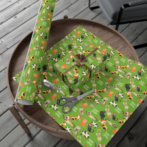 Playful 'Catmas' themed Christmas gift wrap featuring cats in Christmas hats on a green background, ideal for wrapping presents for cat enthusiasts.