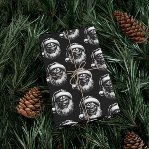 Black gift wrap paper featuring a pattern of the Iron Maiden skeleton head with a Christmas hat, offered in matte and satin finishes, perfect for wrapping holiday gifts with a metal twist