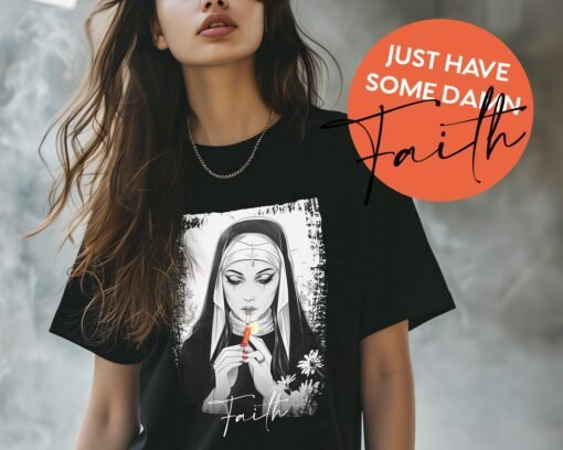 Edgy grunge-style tee featuring a gothic nun lighting a cigarette with a sparkler, with the word 'Faith' in elegant script below.