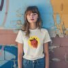 Stylish strawberry graphic tee in a retro design, inspired by pop culture and berry humor, suitable for all