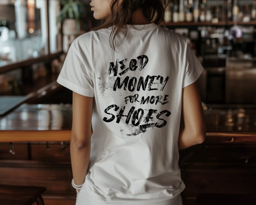 Back view of a streetwear statement T-shirt with 'NEED MONEY FOR MORE SHOES' in black grunge text, designed for stylish teens and young women.